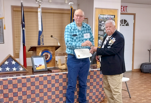 Clarence Burns receives a certificate and pin for his service as President of Ark-La-Tex Chapter #69, Sons of American Revolution from the new President, Larry Joe Reynolds