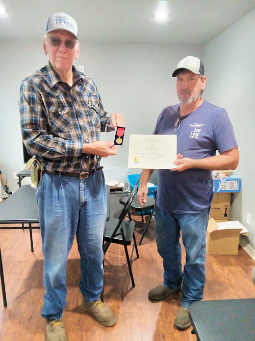 Chapter President Clarence V. Burns presents Fireman Randy Jones with the Hughes Springs Volunteer Fire Department the Fire Safety Commendation Award
