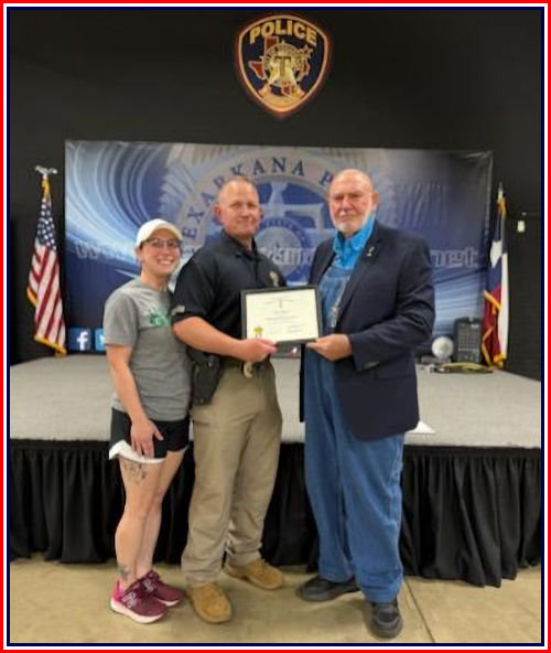Ark-La-Tex Chapter #69 Secretary Rodney Love presents Cory Berry, U.S. Marines, with a Certificate of Appreciation. Cory served 2 tours Middle East, his Humvee hit an IED and Cory was only survivor. He has a Purple Heart Medal, Wounded Warrior Certificate & Coin. Cory is employed by the Texarkana Police Department as Training Officer. He Graduated Linden-Kildare High School. Pictured with him is his wife, Kayla. he served 2 tours in Iraq and has 16 years as Texarkana PD Officer.