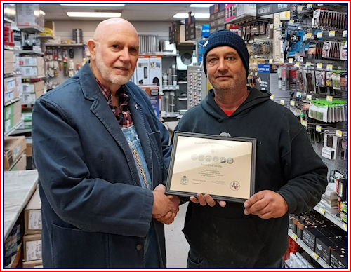 Adjutant Rodney Love presents Jason McConville with a Certificate of Appreciation for his service in the United States Army.