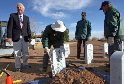 Wiliam Lucky placing stone marker